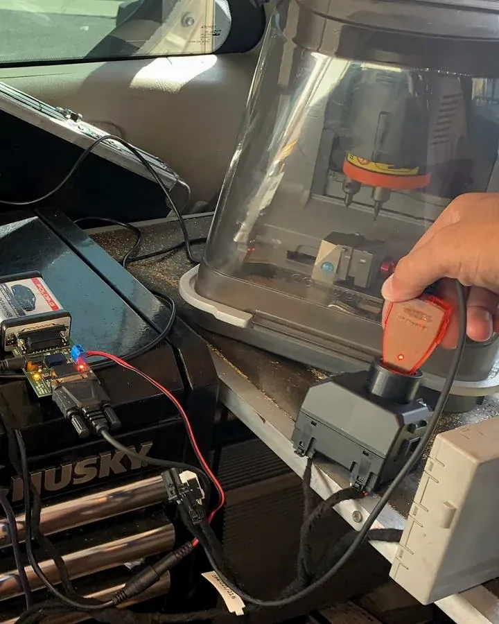 Key cutting machine and key programming tools set up inside a mobile locksmith van