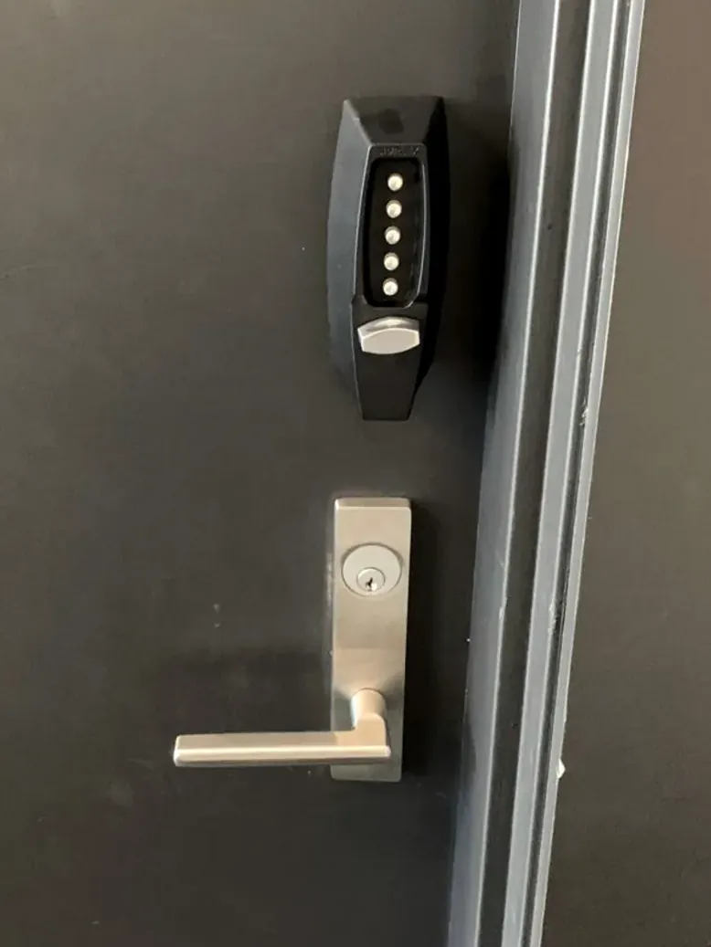 Mechanical keypad lever lock on a black commercial door