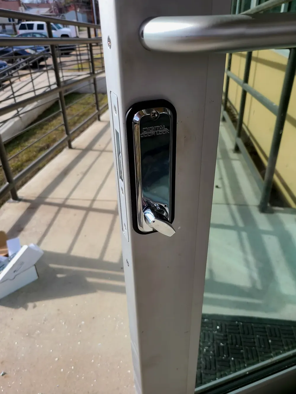 Mechanical push-button code lock on a glass commercial door