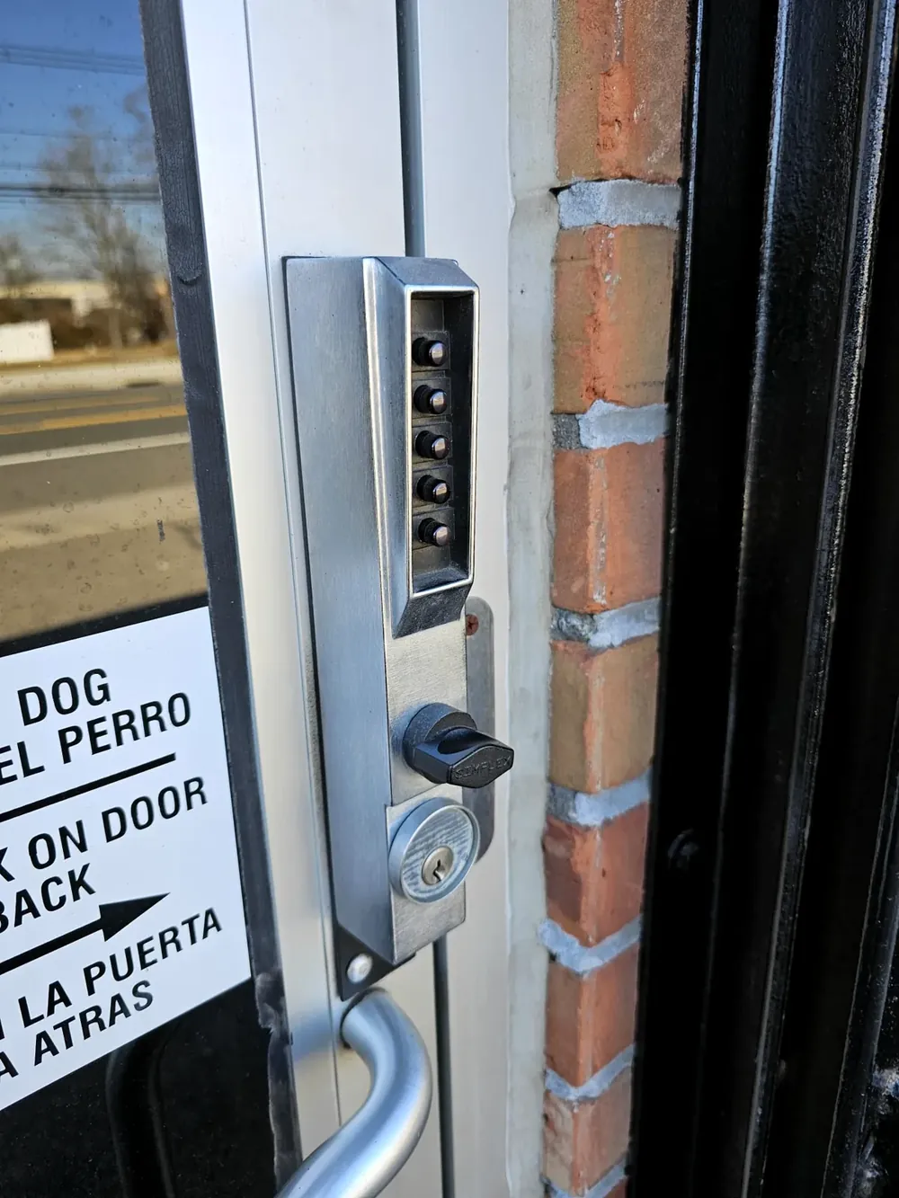 Mechanical keypad lock on an aluminum storefront door