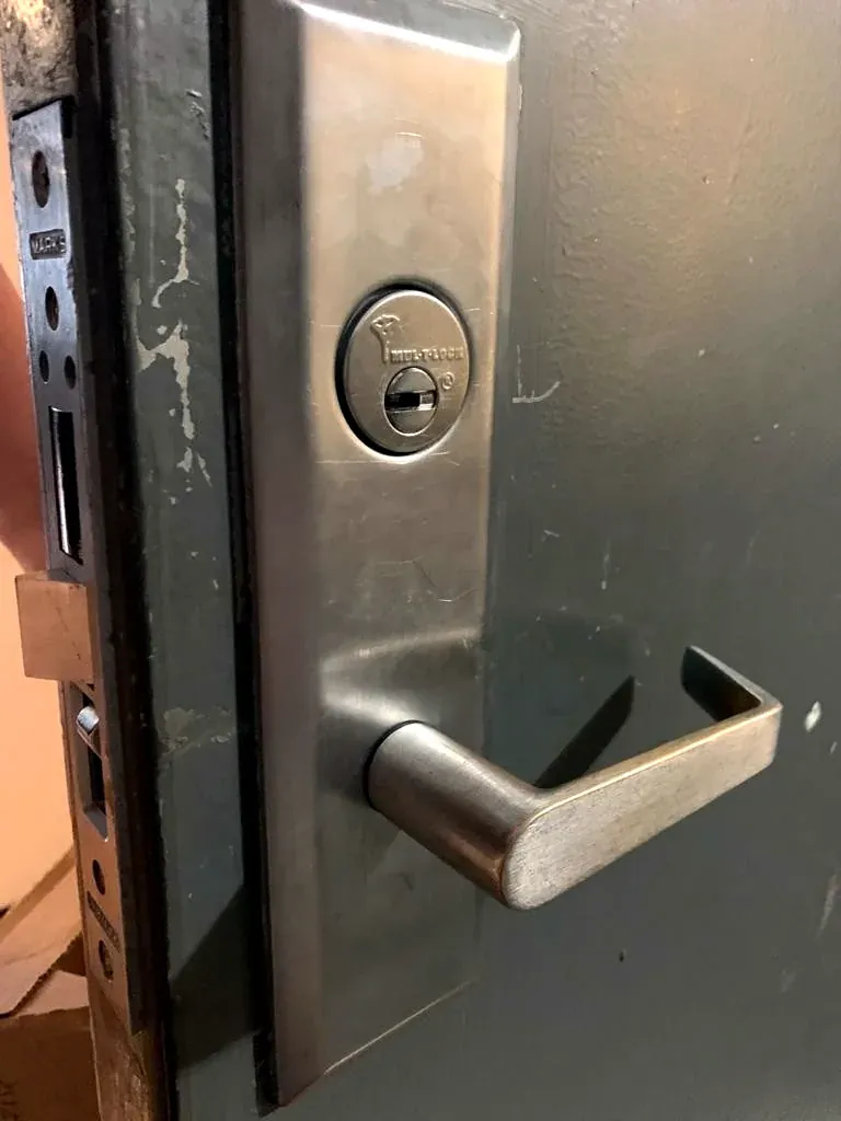 Commercial mortise lever and key cylinder on a shop door