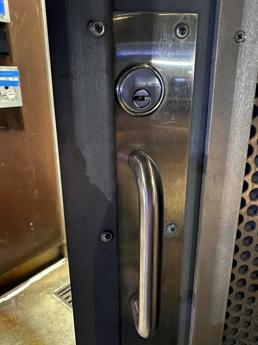 Stainless pull handle and key cylinder on a storefront door