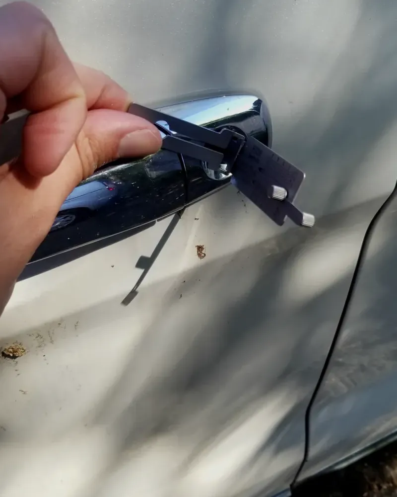 Lishi lock pick tool in a car door lock during a car lockout on Long Island