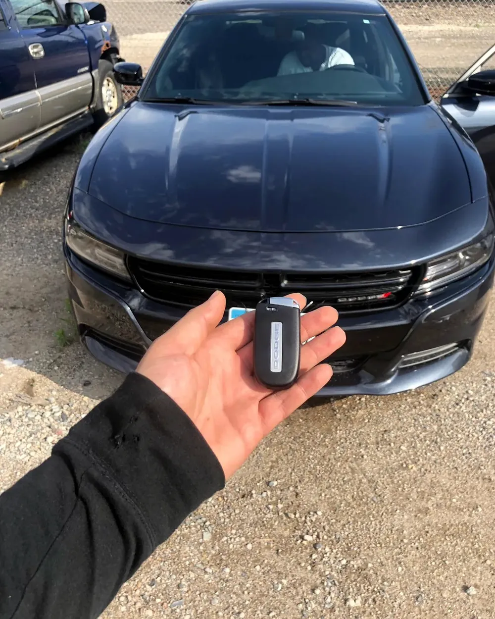 New Dodge Charger smart key held in front of the car by a locksmith serving Baldwin, NY