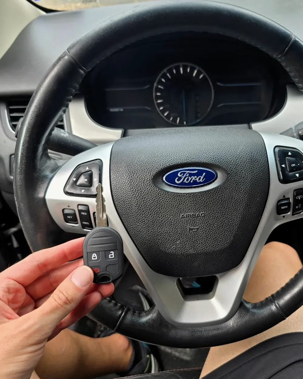 New Ford remote head key held at the steering wheel by a locksmith serving Inwood, NY