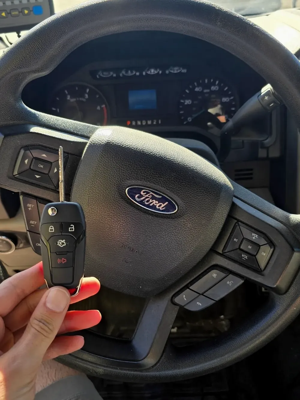 New Ford smart key held at the steering wheel