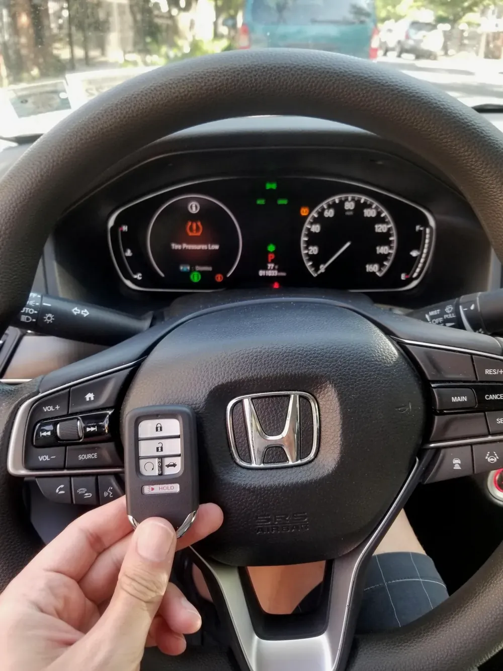 New Honda smart key held at the steering wheel