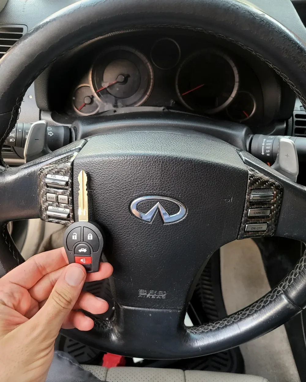 New Infiniti remote head key held at the steering wheel after a job in West Hempstead, NY