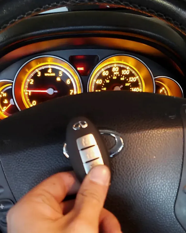New Infiniti smart key held at the steering wheel after a job in Cedarhurst, NY