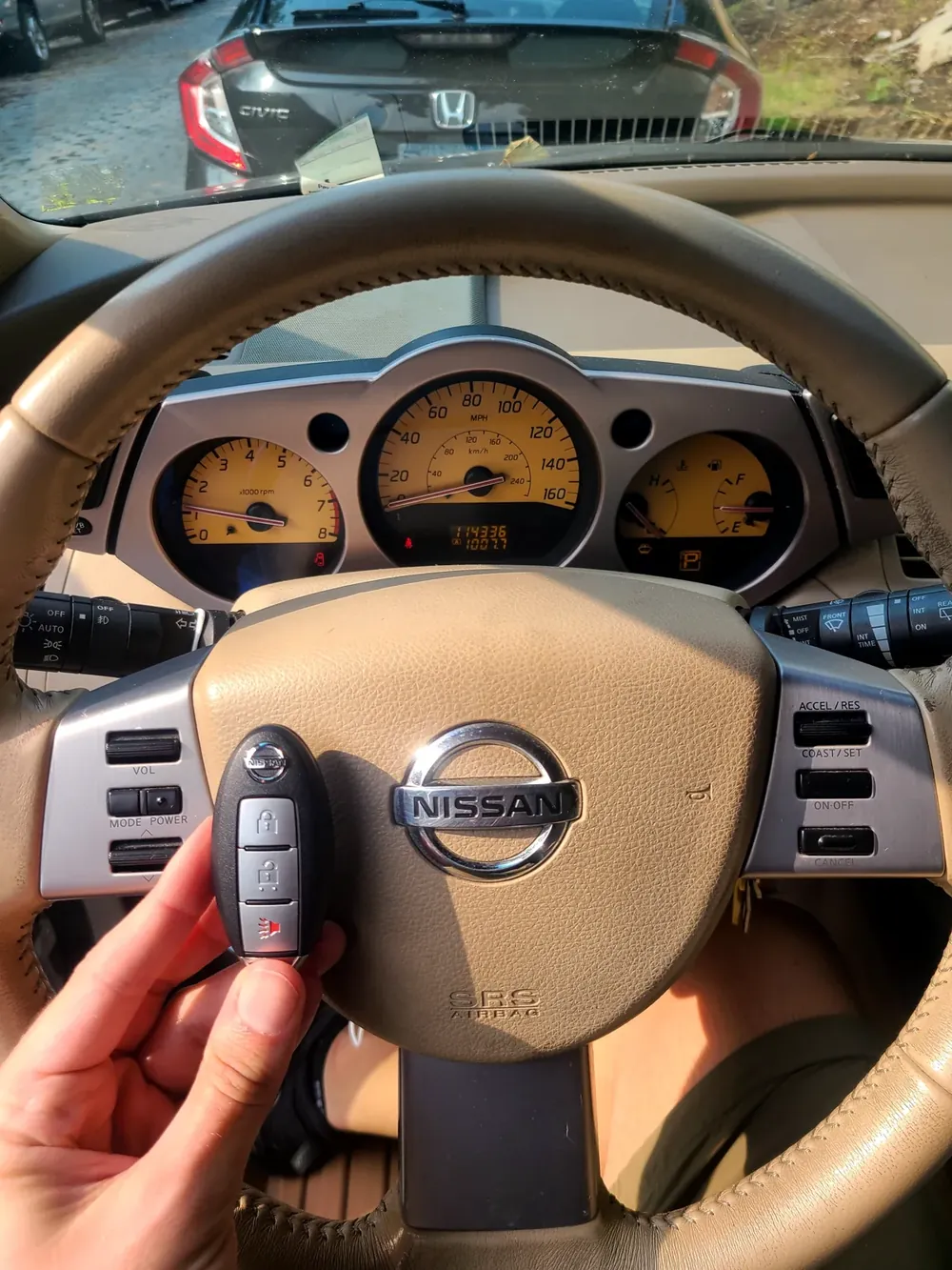 New Nissan smart key held at the steering wheel