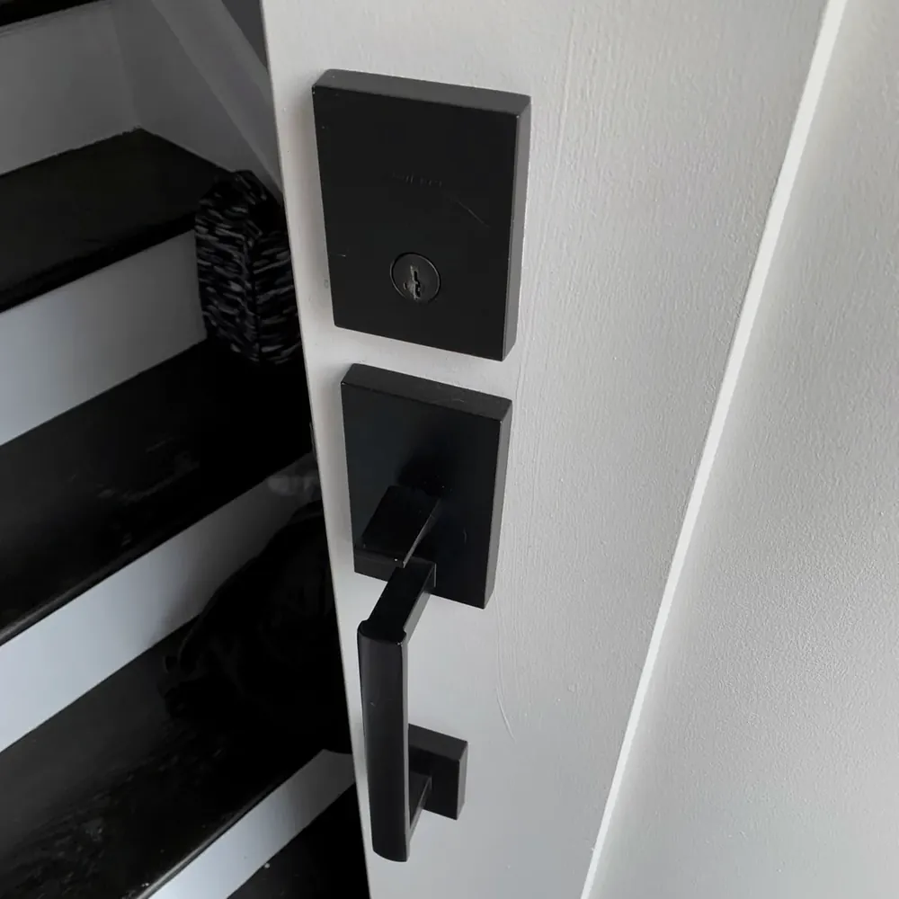 Matte black handleset and deadbolt on a white door