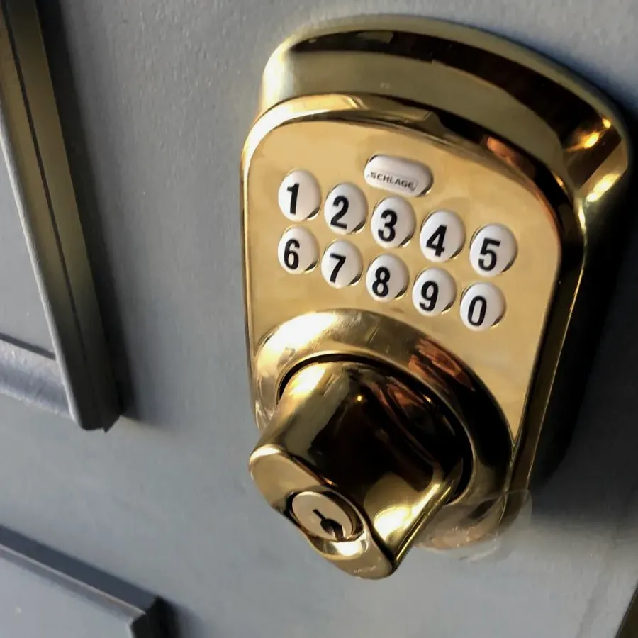 Polished brass keypad deadbolt on a front door