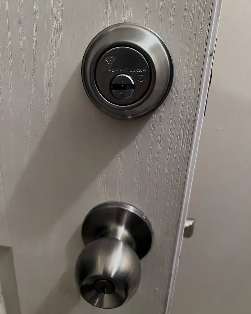 New deadbolt and knob lock installed on a home entry door