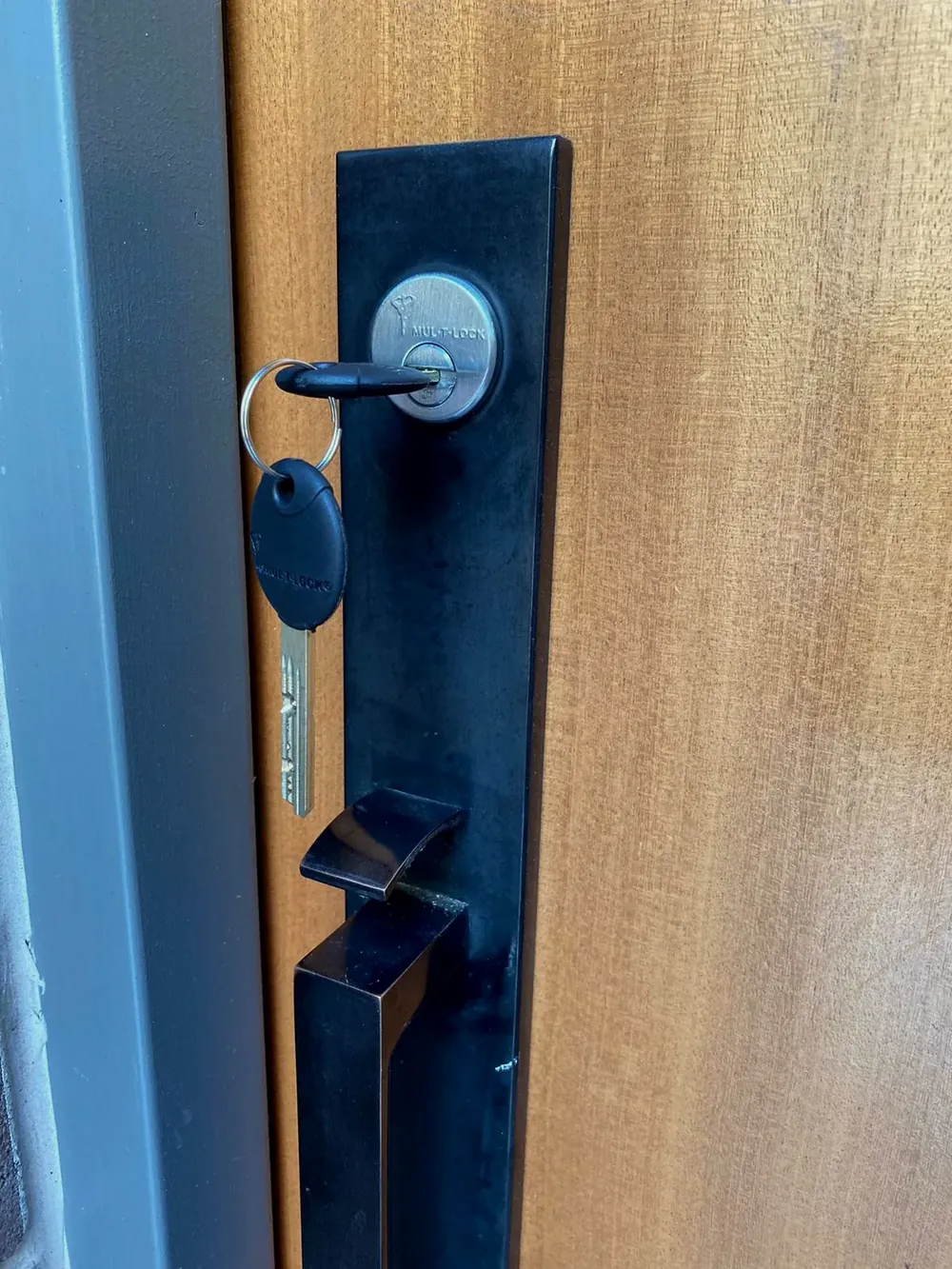 Black handleset with a high-security key in the cylinder