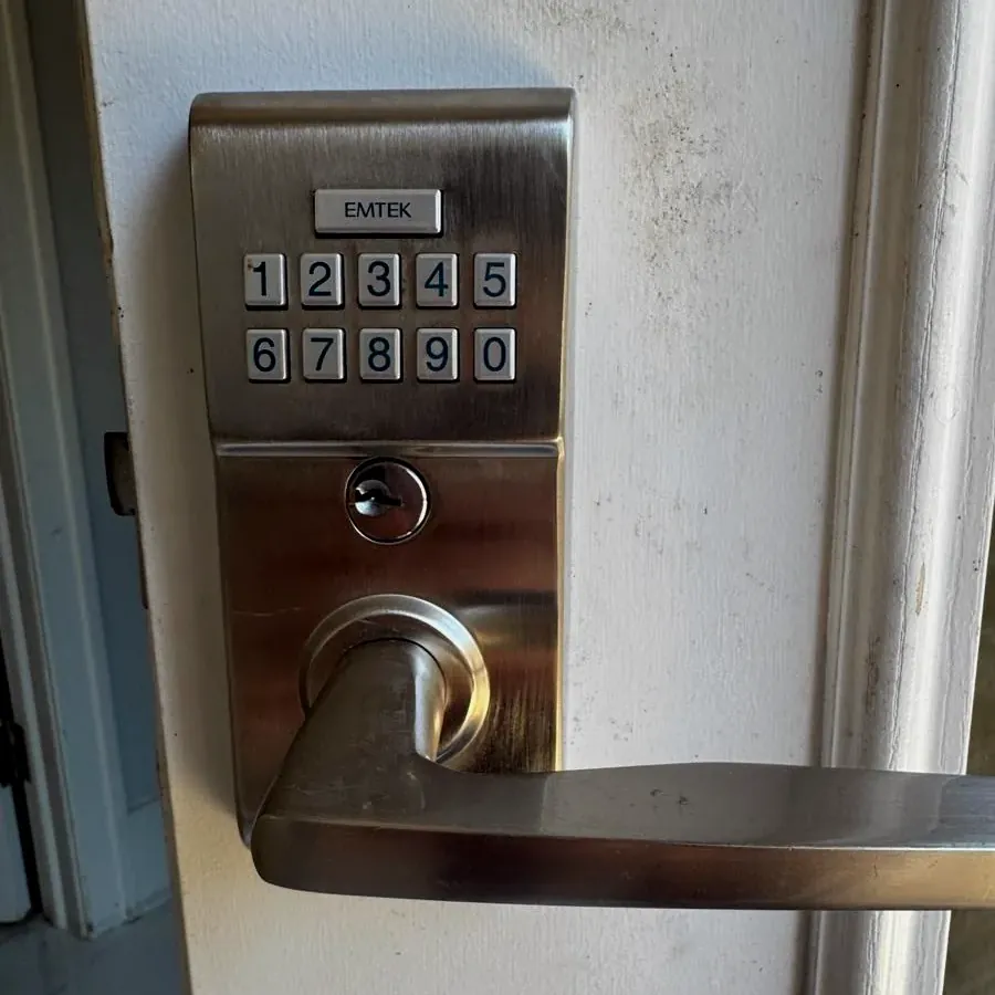 Keypad lever lock on a white door