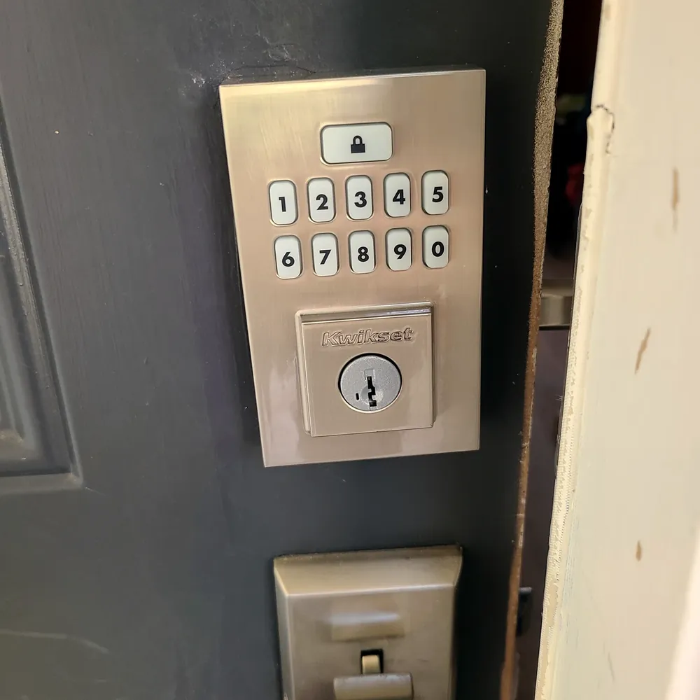 Kwikset keypad deadbolt installed on a gray door