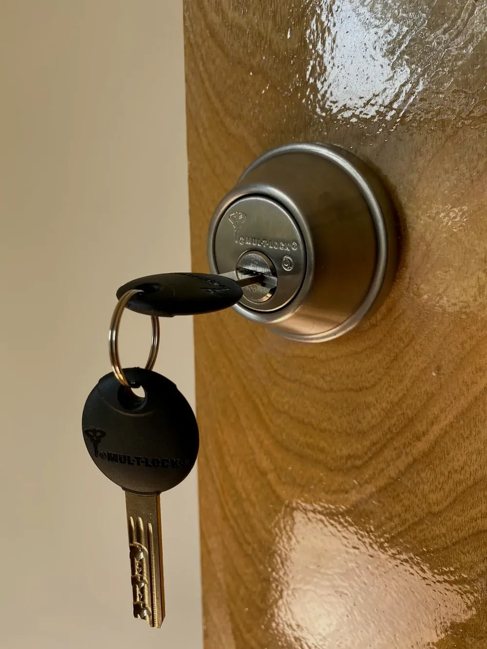 High-security deadbolt with a restricted key in the lock on a wood door