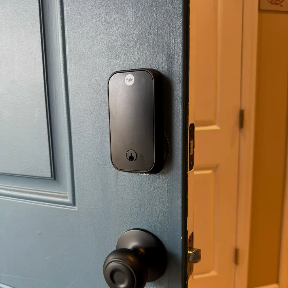 Yale smart lock above a knob on a blue front door